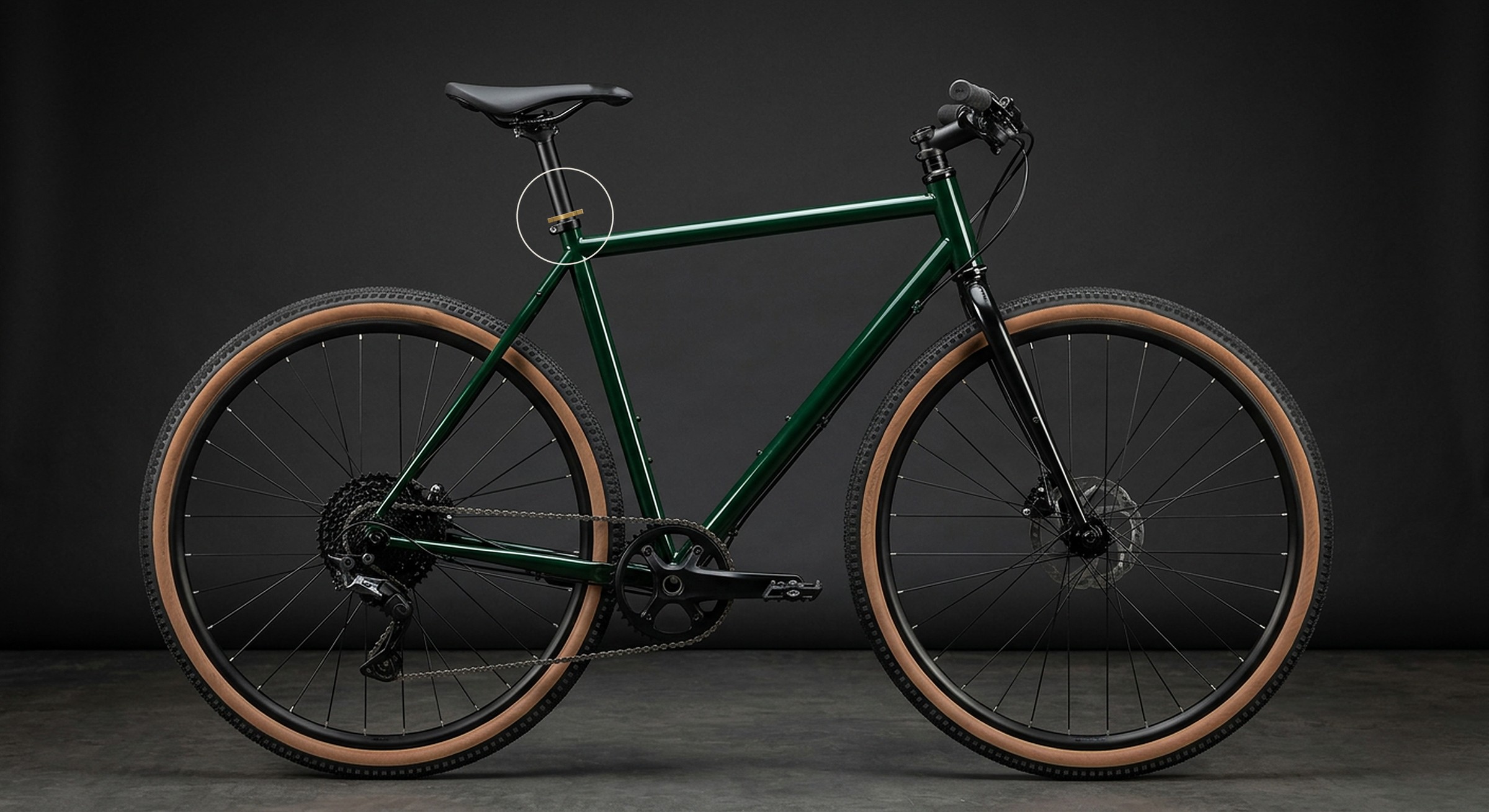 Illustration of a green steel gravel bike in side view, with the Datum collar circled on top of the seat clamp